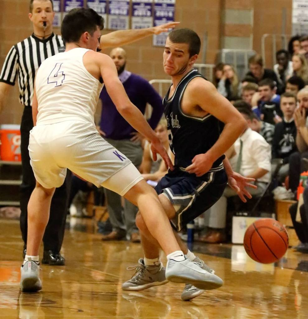 Glacier Peak&rsquo;s Austin Petz attempts to shake the defense of Kamiak&rsquo;s Christian Clausen during a game Friday night at Kamiak High School in Mukilteo. The Grizzles won 63-50. (Kevin Clark / The Herald)