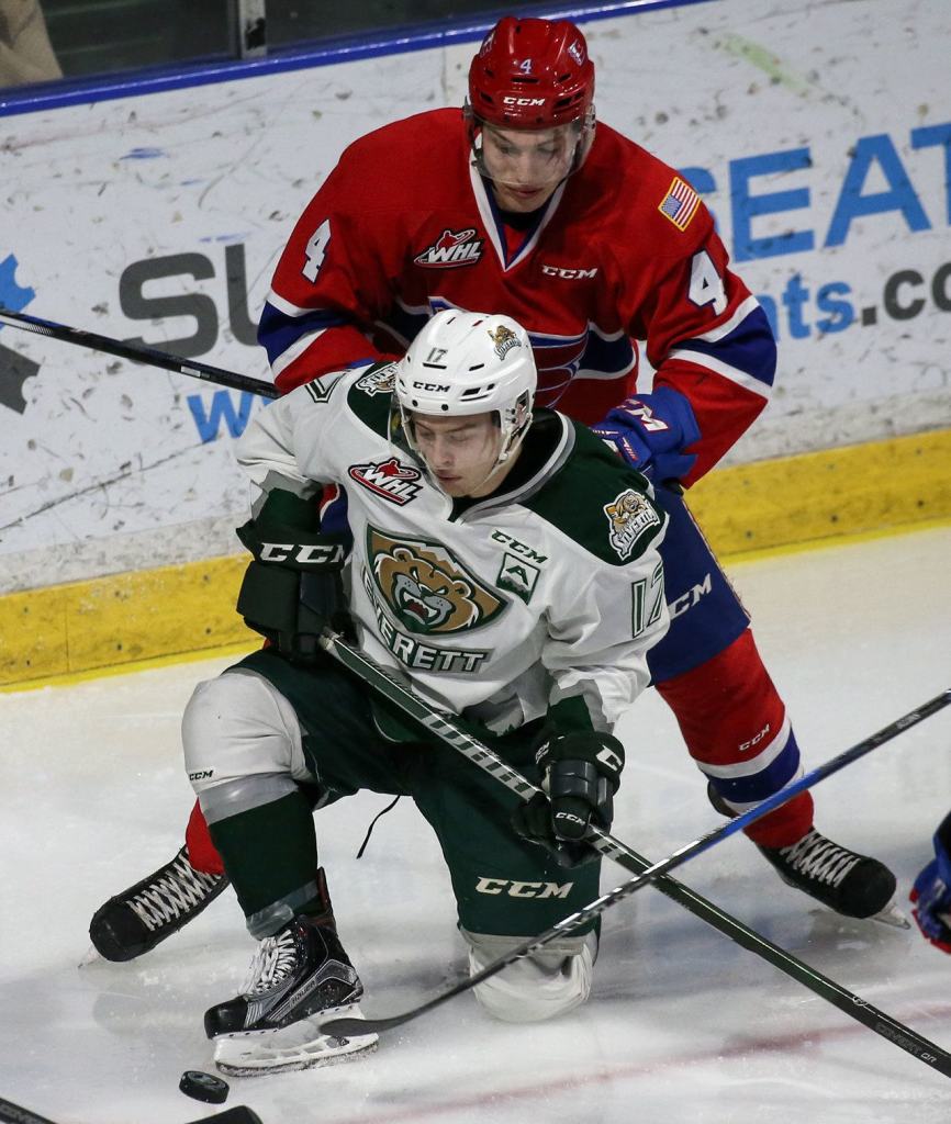 Everett&rsquo;s Matt Fonteyne vies for control of the puck with Spokane&rsquo;s Jeff Faith on his back during the Silvertips&rsquo; 5-0 win over the Chiefs on Wednesday night at Xfinity Arena in Everett. (Kevin Clark / The Herald)