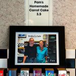 A picture of Joe and Pam Weller hangs just above the soda fountain and just below the Pam&rsquo;s Homemade Carrot Cake sign. (Dan Bates / The Herald)
