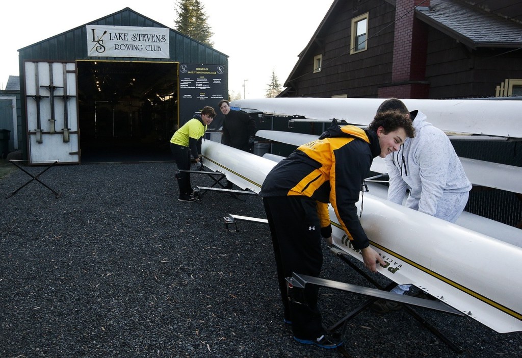 Club member Ben Wilson (center right) puts away a shell following practice. (Ian Terry / The Herald)