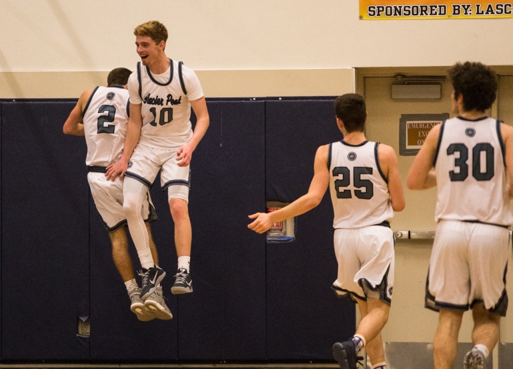 Glacier Peak&rsquo;s Seiver Southard and Austin Petz celebrate after the Grizzlies scored during a game against Monroe on Tuesday. Glacier Peak beat Monroe 56-46. (Daniella Beccaria / The Herald)