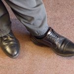 Mike Papadimitriou, owner of People&rsquo;s Shoe Repair, wears a pair of American-made Allen Edmonds shoes at his shop. (Andy Bronson / The Herald)