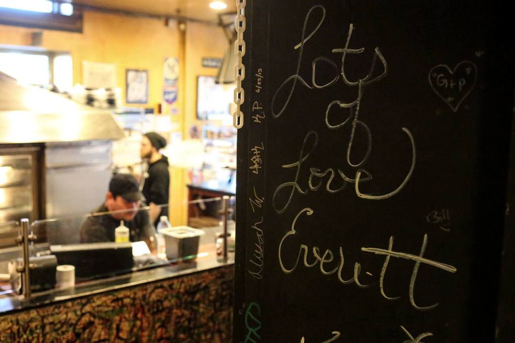 The walls of Brooklyn Bros. Pizzeria are liberally decorated in signatures and graffiti at the downtown Everett shop. (Kevin Clark / The Herald)