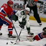 Everett&rsquo;s Bradly Goethals (center) vies for control of the puck with Spokane&rsquo;s Jeff Faith (left) and Spokane&rsquo;s Dawson Weatherill defending during the Silvertips&rsquo; 5-0 win over the Chiefs on Wednesday night at Xfinity Arena in Everett. (Kevin Clark / The Herald)