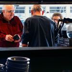Even at the cash register, saying goodbye to customers who have become friends can be difficult. Joe tells Bob and Carol Peters, who have been coming to Weller&rsquo;s since he and Pam opened 16 years ago, that there is plenty of time for them to come back. He will be open till Sunday, he reminds them. (Dan Bates / The Herald)