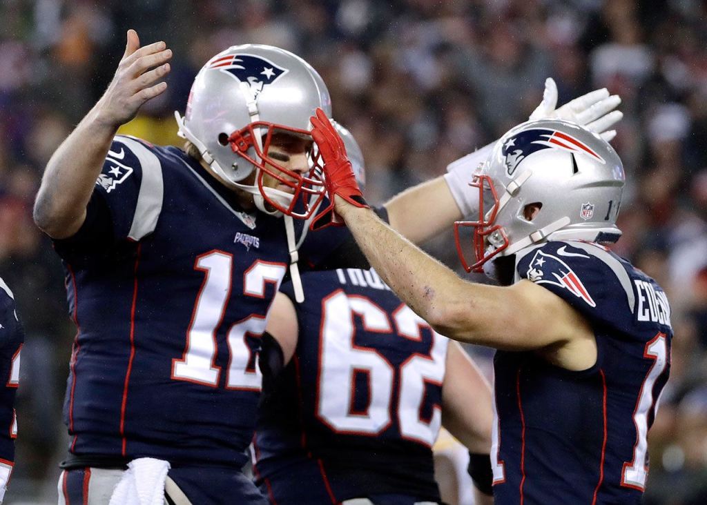 New England Patriots quarterback Tom Brady (12) celebrates with wide receiver Julian Edelman (11) after throwing a touchdown pass. (AP Photo/Matt Slocum)