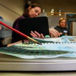 Class leader Karen Dawn works with a red paintbrush on her own journal (foreground) while Susan Curtis (middle) and Dawn Everett (back) concentrate on theirs. (Dan Bates / The Herald)