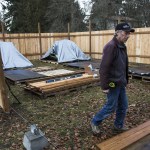 Tony Thompson works on the new homeless students living site at Good Shepherd Baptist Church on Tuesday in Lynnwood. Thompson helped construct the site and is now one of the patrols who provides daily security for the residents. (Daniella Beccaria / The Herald)
