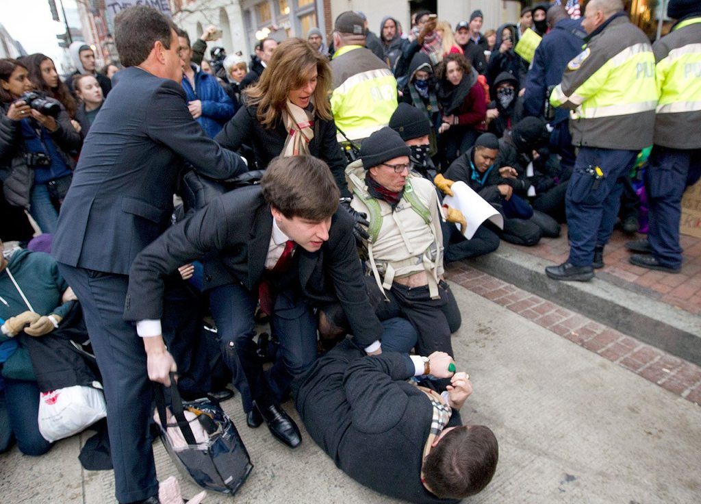 Inaugural attendees move through demonstrators attempting to block people entering a security checkpoint Friday, Jan. 20, ahead of President-elect Donald Trump&rsquo;s inauguration in Washington. (AP Photo/Jose Luis Magana)
