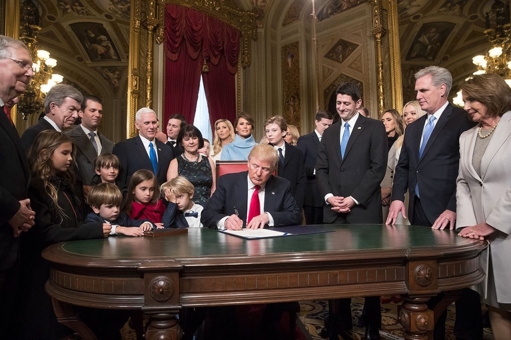 President Donald Trump is joined by the Congressional leadership and his family as he formally signs his cabinet nominations into law Friday, Jan. 20, in the President&rsquo;s Room of the Senate on Capitol Hill in Washington. From left are, Senate Majority Leader Mitch McConnell, Sen. Roy Blunt, Donald Trump Jr., Vice President Mike Pence, Jared Kushner, Karen Pence, Ivanka Trump, Melania Trump, Barron Trump, Speaker of the House Paul Ryan, Majority Leader Kevin McCarthy and House Minority Leader Nancy Pelosi. (AP Photo/J. Scott Applewhite, Pool)