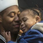As his fellow crew heads to the mess hall to meet their families, Seaman Sean Tender and daughter Sydney, 2, hold each other after the USS Kidd docks at Everett Naval Station on Monday, Nov. 21, 2016 in Everett, Wa. (Andy Bronson / The Herald)