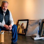 Late last week at the Schack Art Center, artist Chris Hopkins unpacks a few of his Tuskegee Airmen paintings while exhibit hanger, Josey Wise prepares walls nearby. The paintings uncovered behind him are &ldquo;The Flyer of the 332nd. (left) and &ldquo;The Commander and the Plan.&rdquo; (Dan Bates / The Herald)