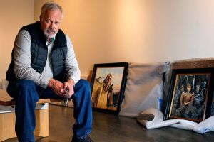 Late last week at the Schack Art Center, artist Chris Hopkins unpacks a few of his Tuskegee Airmen paintings while exhibit hanger, Josey Wise prepares walls nearby. The paintings uncovered behind him are &ldquo;The Flyer of the 332nd. (left) and &ldquo;The Commander and the Plan.&rdquo; (Dan Bates / The Herald)