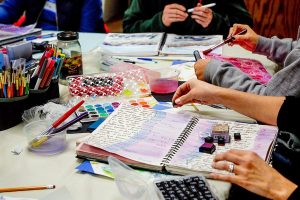 Using a variety of tools and media, women express themselves through visual journaling last week at ArtWorks in Edmonds. (Dan Bates / The Herald)