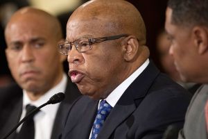 Rep. John Lewis, D-Ga. (center) flanked by Sen. Cory Booker, D-N.J., (left) and Congressional Black Caucus Chair Rep. Cedric Richmond, of La., testifies on Capitol Hill in Washington, D.C., on Wednesday. (Cliff Owen / Associated Press)