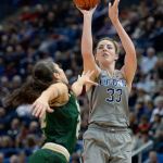 Connecticut&rsquo;s Katie Lou Samuelson shoots over South Florida&rsquo;s Laia Flores (left) in the first half of Tuesday&rsquo;s game in Hartford, Connecticut. (AP Photo/Jessica Hill)