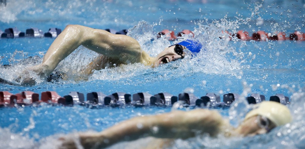 Shorewood&rsquo;s Andrew Butcher (top) takes a breath as he swims the final length on the way to second place behind Bainbridge&rsquo;s Jude Wenker (bottom) in the 100-yard freestyle race at the 3A State Boys Swimming and Diving Championship at the King County Aquatic Center on Feb. 18, 2017. (Ian Terry / The Herald)