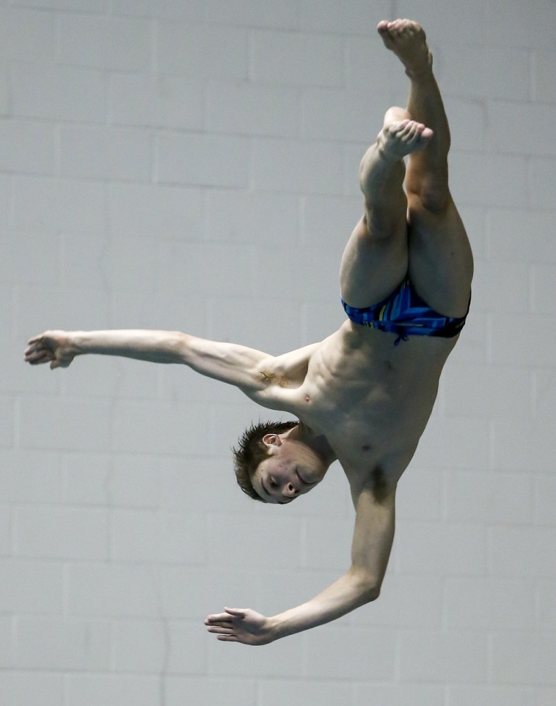 Snohomish&rsquo;s Zack Thomas rotates through the air on the way to finishing in third place in the dive competition at the 3A State Boys Swimming and Diving Championship at the King County Aquatic Center in Federal Way on Feb. 18, 2017. (Ian Terry / The Herald)