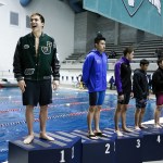 Jackson&rsquo;s Jonathan Cook (left) smiles from the podium after winning the 100-yard breaststroke race at the 4A State Boys Swimming and Diving Championship at the King County Aquatic Center in Federal Way on Feb. 18, 2017. Cook&rsquo;s time of 53.91 set a meet record. (Ian Terry / The Herald)