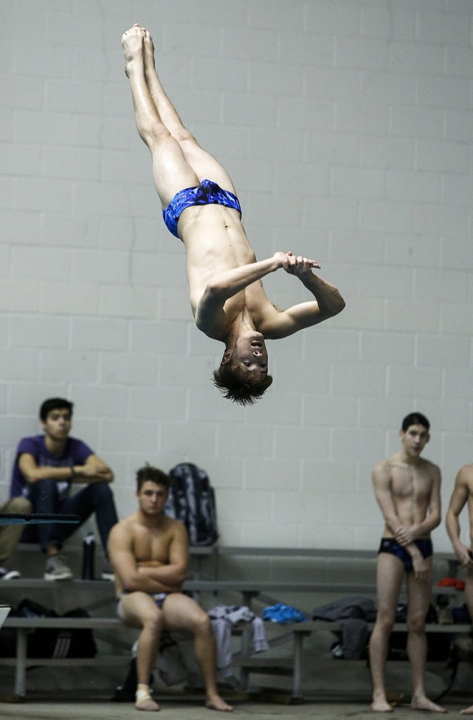 Glacier Peak&rsquo;s Connor May extends in the air during the diving competition at the 4A State Boys Swimming and Diving Championship at the King County Aquatic Center in Federal Way on Feb. 18, 2017. May placed third in the competition. (Ian Terry / The Herald)