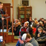 A packed crowd appears to receive Lynnwood Police Chief Tom Davis warmly Friday at the Evergreen Islamic Institute. Davis spoke about immigration policy and how the police department and Muslim community can work together. (Dan Bates / The Herald)