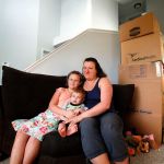 Maria Corcoran and her daughter, Ana, 8, hold her 11-month old son, Jimmy, at their new home in Lake Stevens Friday. Maria&rsquo;s husband, Jay Corcoran, died on Valentine&rsquo;s Day, just a week after the family moved from Utah to Lake Stevens. (Dan Bates / The Herald)