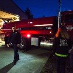 Oso firefighter and chaplain Joel Johnson and firefighters Cyndy Olson and Bill Reynolds inspect the newly repaired firetruck at the Oso fire station on Tuesday, Feb. 21. (Daniella Beccaria / The Herald)