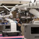 Materials handler 3 Terry Cline gets an Epiq Ultrasound machine ready for shipping at the Philips headquarters on the Bothell-Everett Highway. (Andy Bronson / The Herald)