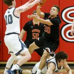 Monroe&rsquo;s Isaiah Cole (30) battles for a loose ball with Glacier Peak&rsquo;s Seiver Southard (10) and Bobby Martin (bottom) during the Class 4A District 1 boys basketball championship game at Everett Community College on Thursday, Feb. 16. (Ian Terry / The Herald)