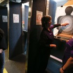 Bonnie Stecher (center), a founder and instructor in Snohomish County&rsquo;s chapter of The Well Armed Woman group, goes over a target with Marlene Wing (right), of Marysville, and Brianna Badger (left), of Arlington, at the Norpoint Shooting Center in Arlington on Saturday, Feb. 4. (Ian Terry / The Herald)