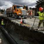 Work on a temporary bypass pipeline continues Thursday near Lake Serene&rsquo;s public boat launch in Lynnwood. Record-high water levels this winter have waterlogged properties on the lake. (Ian Terry / The Herald)