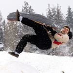 Jalen Velasquez, a junior at Stanwood High School, gets airborne after hitting a jump while sledding at the school on Monday. (Andy Bronson / The Herald)