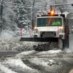 Snow plows, including this one on 20th Street SE between Everett and Lake Stevens, were clearing snow and slush from as many streets as possible before temperatures dropped again Monday night. (Dan Bates / The Herald)