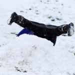 A sledder is inverted as he tries to go over a small jump at Stanwood High School on Monday. (Andy Bronson / The Herald)                                A sledder flips after hitting a small jump at Stanwood High School on Monday. (Andy Bronson / The Herald)