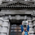 Karen Shore holds up a sign outside of the 9th U.S. Circuit Court of Appeals in San Francisco on Tuesday. A panel of appeals court judges reviewing President Donald Trump&rsquo;s travel ban hammered away Tuesday at the federal government&rsquo;s arguments that the states cannot challenge the order. (AP Photo/Jeff Chiu)