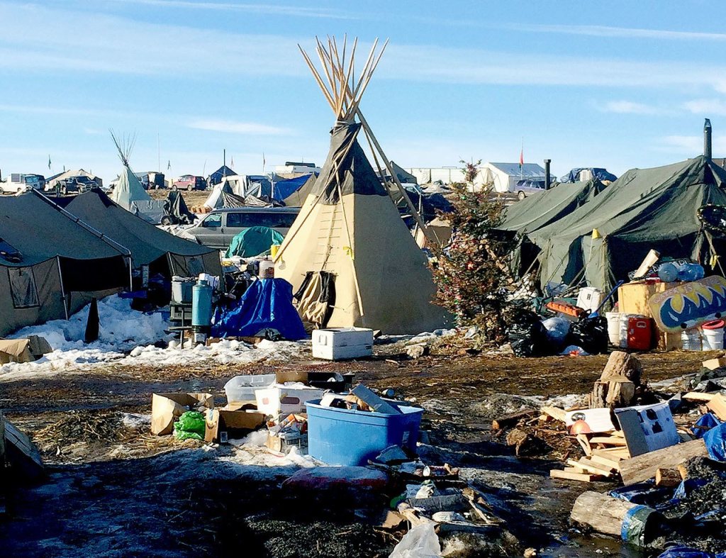 Debris is piled on the ground awaiting pickup by cleanup crews last week at the Dakota Access oil pipeline protest camp in southern North Dakota near Cannon Ball. (AP Photo/Blake Nicholson)