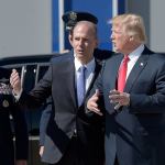 President Donald Trump talks with Boeing CEO Dennis Muilenburg upon his arrival by Air Force One at Charleston International Airport in North Charleston, South Carolina, on Friday. (AP Photo/Susan Walsh)