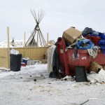 Trash is seen piled in a dumpster at an encampment set up near Cannon Ball, North Dakota, on Wednesday, Feb. 8, for opponents against the construction of the Dakota Access pipeline. (AP Photo/James MacPherson)