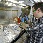Caleb Ogier, a PhD student in mechanical engineering at the University of Washington, works in a fume hood with ink used to print electrical circuits at the newly opened Washington Clean Energy Testbeds lab housed in the University of Washington&rsquo;s Clean Energy Institute, on Monday, Feb. 13, in Seattle. (AP Photo/Ted S. Warren)