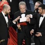 &ldquo;La La Land&rdquo; producer Jordan Horowitz (left), presenter Warren Beatty (center) and host Jimmy Kimmel (right) look at an envelope announcing &ldquo;Moonlight&rdquo; as best picture at the Oscars on Sunday, Feb. 26, at the Dolby Theatre in Los Angeles. (Photo by Chris Pizzello/Invision/AP)