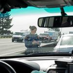 Washington State Patrol Trooper Heather Axtman takes down the license of a car after giving the driver a warning in March 2016 on I-5 in Everett. (Andy Bronson / Herald file)