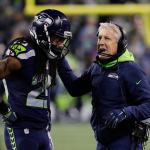 Seahawks head coach Pete Carroll talks with cornerback Richard Sherman during a playoff game against the Lions on Jan. 7 in Seattle. (AP Photo/Elaine Thompson)