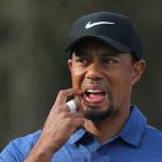 Tiger Woods reacts on the 11th hole during the first round of the Dubai Desert Classic on Feb. 2 in Dubai, United Arab Emirates. Woods pulled out of his next two tournaments because of ongoing back problems. (AP Photo/Kamran Jebreili)