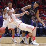 Utah forward Tyler Rawson (21) hits the deck after a collision with Washington forward Devenir Duruisseau (24) during a game Feb. 11, 2017, in Salt Lake City. (Leah Hogsten/The Salt Lake Tribune)