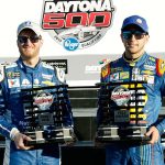 Dale Earnhardt Jr. (left) and Chase Elliott display their front-row trophies after qualifying for the top two positions in the NASCAR Daytona 500 on Sunday at Daytona International Speedway. (AP Photo/Terry Renna)