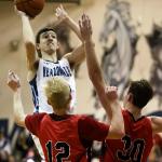 Meadowdale&rsquo;s Daniel Barhoum attempts a shot over Snohomish&rsquo;s Tristan MacGregor (left) and Kole Bride (right) during a 3A district play-in game Feb. 10, 2017, at Meadowdale High School in Lynnwood. The Mavericks won 66-54. (Kevin Clark / The Herald)