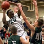 Shorecrest&rsquo;s Philip Pepple (top left) attempts a shot with Edmonds-Woodway&rsquo;s Michael Epoch (5) and Ryan Peterson (40) defending during a state regional playoff game Feb. 25, 2017, at Bothell High School. Shorecrest won 74-63. (Kevin Clark / The Herald)