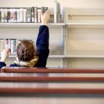 Kerry Spaulding stocks audio books at the new Mariner Library in Everett on Feb. 2. The demonstration community library will carry more than 16,000 titles, and will open Saturday. (Kevin Clark / The Herald)
