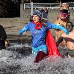 Fundraisers rush the 38 degree waters of Lake Stevens during the 2nd Annual SSS Polar Bear Plunge at Lundeen Park on Jan. 14. (Kevin Clark / The Herald)