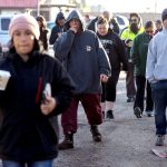 Casual workers stroll away from the International Longshore and Warehouse dispatch hall in Wilmington, California, where some lucky workers obtain day jobs and others go home empty-handed. (Mark Boster / Los Angeles Times)